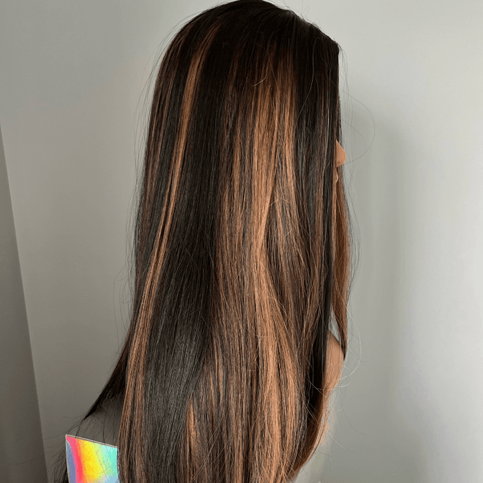 Mannequin head with long brown hair on a white background