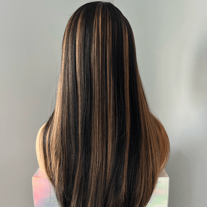 Mannequin head with long, dark brown hair on a gray background