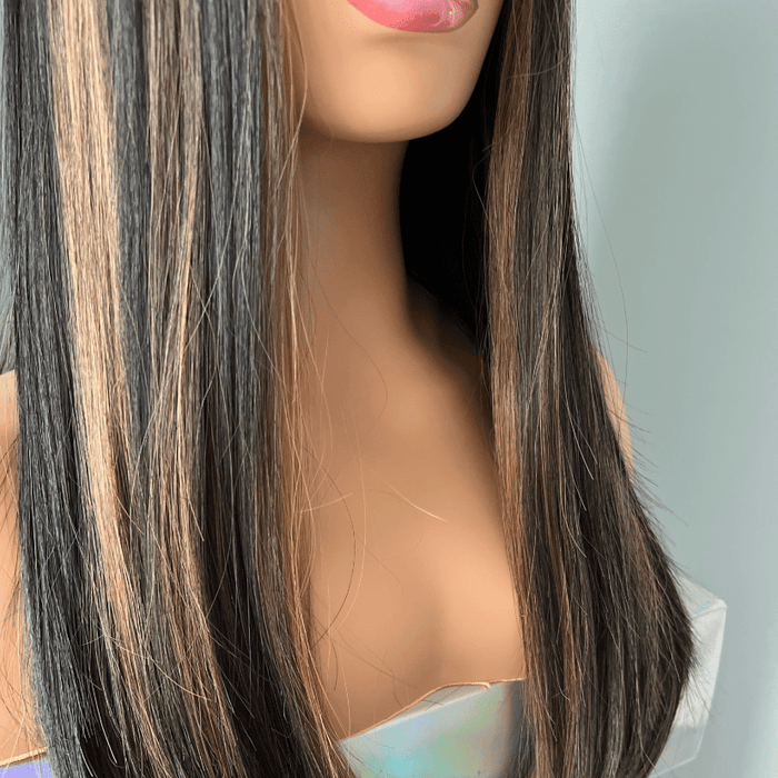 Mannequin head with long black and brown hair on a white background