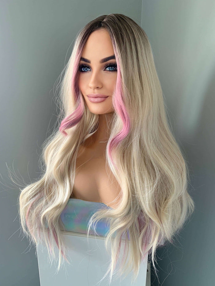 Wig with blonde and pink ombre hair on a neutral background