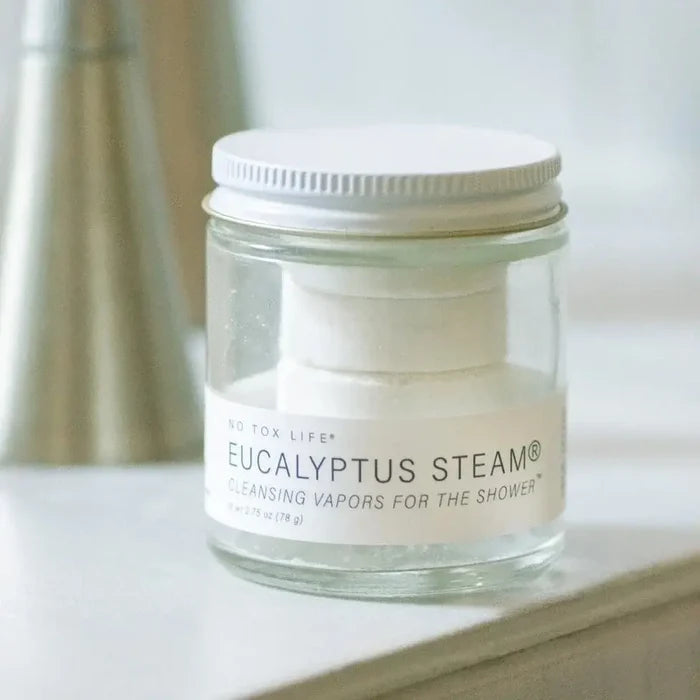 Jar of Eucalyptus Steam product on a bathroom counter