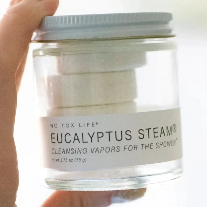 Jar of Eucalyptus Steam cleansing vapors held by a hand