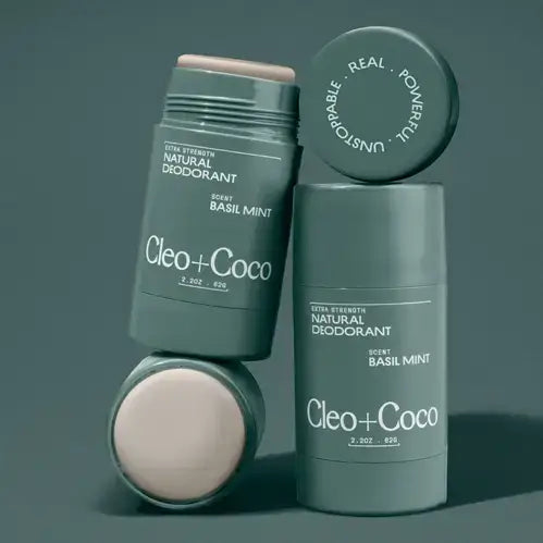 Cleo + Coco natural deodorant sticks on a dark background