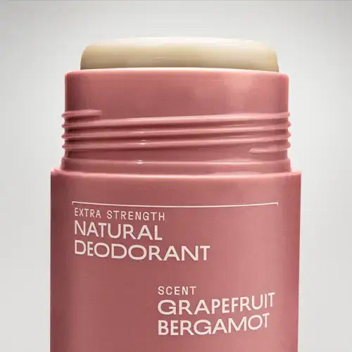 Pink deodorant stick with 'Extra Strength Natural Deodorant' text on a light gray background