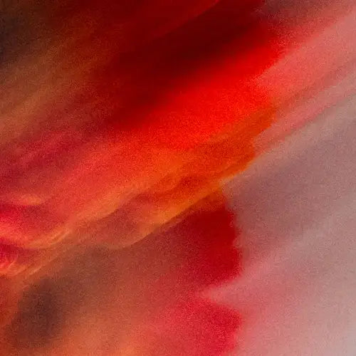 Abstract art with red and orange hues on a textured surface