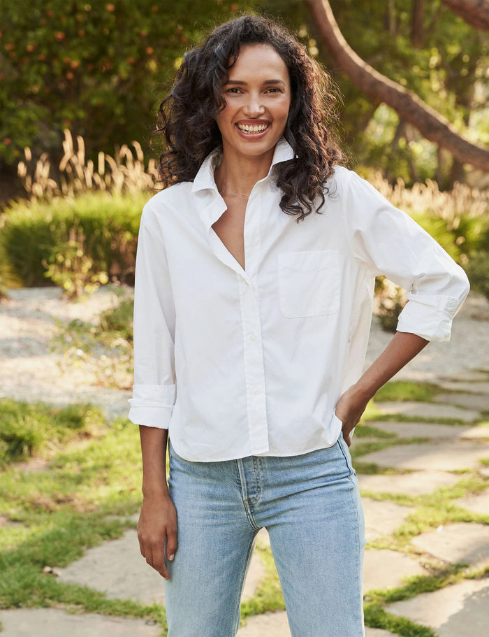 The FRANK & EILEEN Silvio Untuckable Button-Up Shirt in Superluxe Cotton, featuring a chest pocket and rolled-up sleeves, is laid flat on a textured surface. The inside label reads "Frank & Eileen EST 1947.
