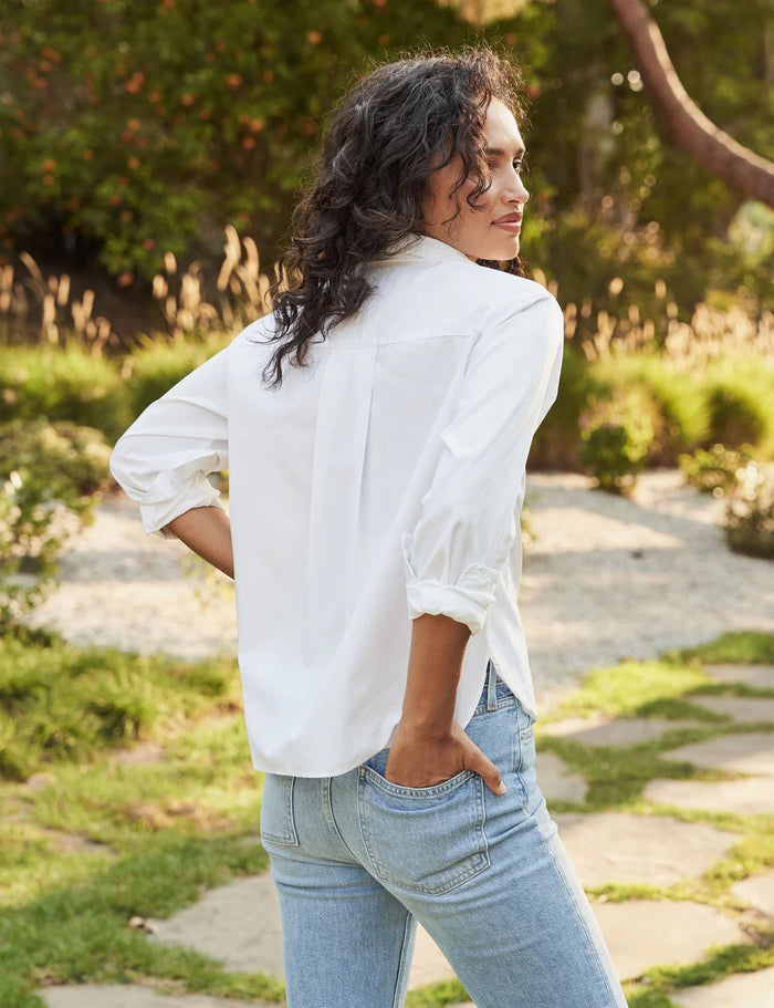 The FRANK & EILEEN Silvio Untuckable Button-Up Shirt in Superluxe Cotton, featuring a chest pocket and rolled-up sleeves, is laid flat on a textured surface. The inside label reads "Frank & Eileen EST 1947.