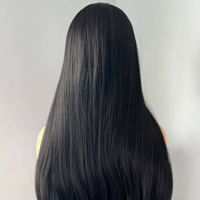 Black wig on a mannequin head against a plain background