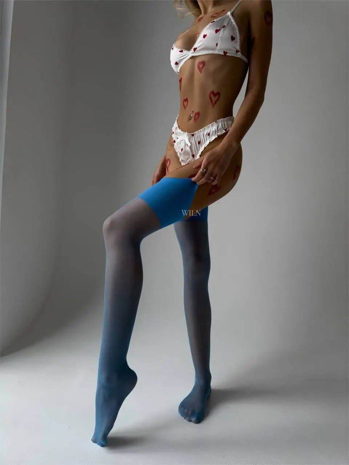 Model showcasing GLAM Stockings Blue with heart-patterned lingerie, highlighting the elegant glossy sheer finish.
