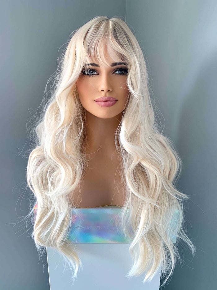 Gwen Long Blonde Layered Wig with Bangs showcasing soft, beachy waves and curtain bangs, ideal for a glamorous look.