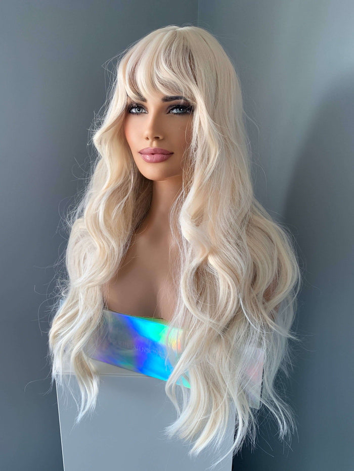 Gwen Long Blonde Layered Wig with Bangs displayed on a mannequin showing soft waves and a glam look.