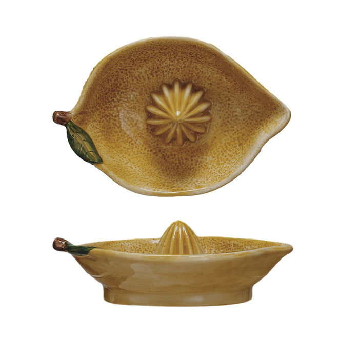 The CREATIVE COOP HAND-PAINTED STONEWARE LEMON SHAPED JUICER features a ribbed center for juicing and a shallow bowl for catching liquid—an ideal farmhouse kitchen décor accent.