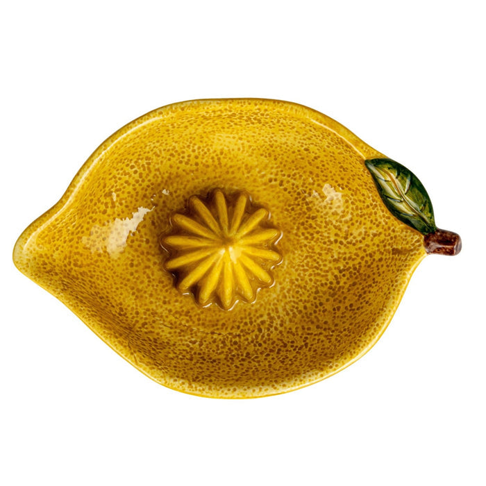 The CREATIVE COOP HAND-PAINTED STONEWARE LEMON SHAPED JUICER features a ribbed center for juicing and a shallow bowl for catching liquid—an ideal farmhouse kitchen décor accent.