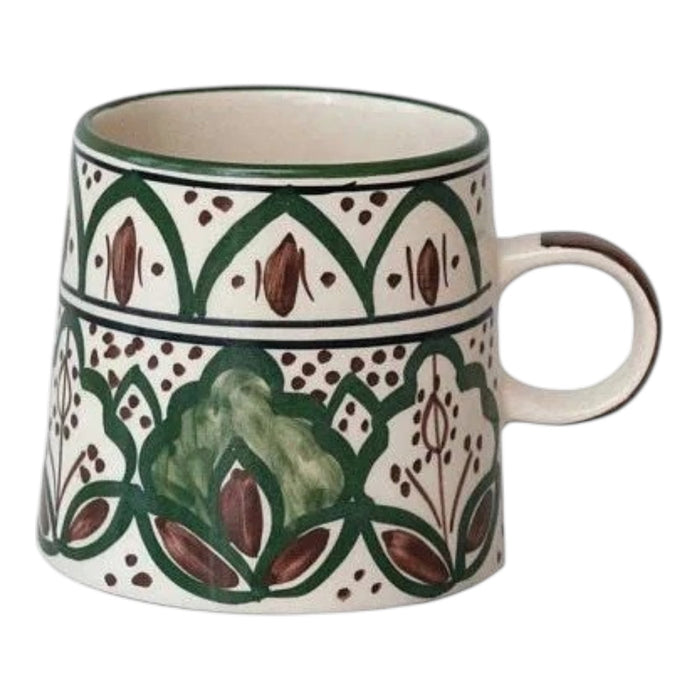 The CREATIVE COOP HAND-PAINTED STONEWARE MUG features a green and brown floral pattern and measures 3.5 inches high by 3.75 inches wide, as illustrated with measurement indicators.