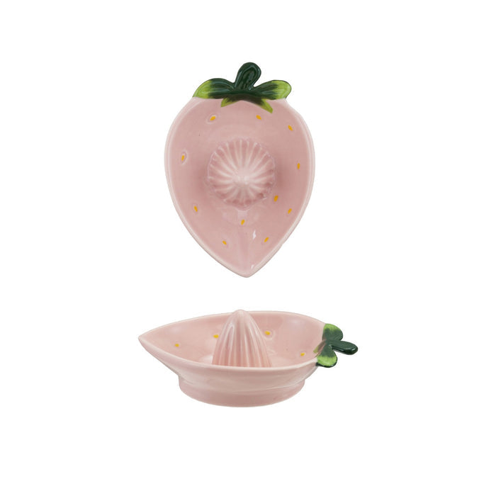 Two views of the HAND-PAINTED STONEWARE STRAWBERRY SHAPED JUICER by CREATIVE COOP: a unique artisan piece with pink strawberry design and green leaves, shown from both the top and side—perfect kitchen decor for fruit lovers.