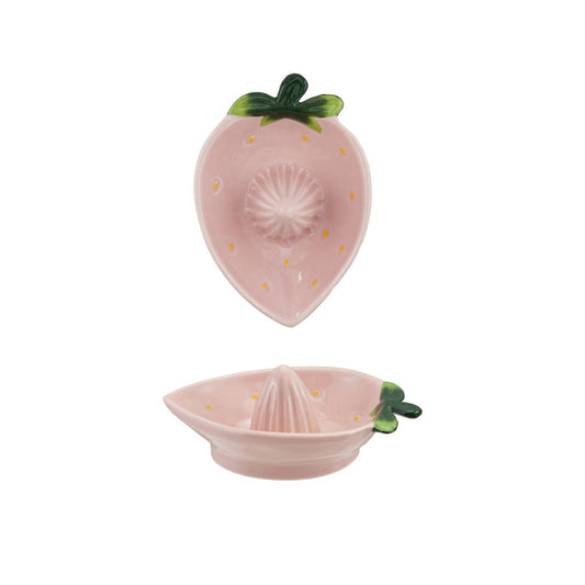 Two views of the HAND-PAINTED STONEWARE STRAWBERRY SHAPED JUICER by CREATIVE COOP: a unique artisan piece with pink strawberry design and green leaves, shown from both the top and side—perfect kitchen decor for fruit lovers.