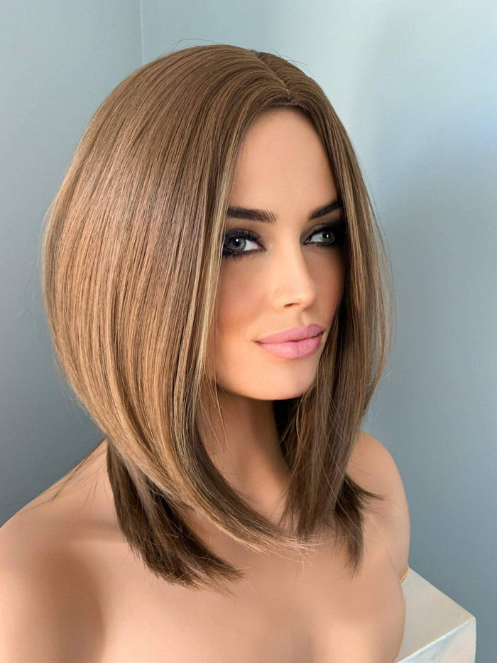 Woman with a styled bob haircut against a plain background