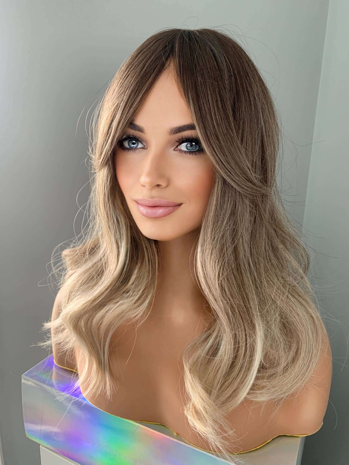 Harlow Rooted Ash Light Brown Wig with Bangs showcasing loose waves and curtain bangs