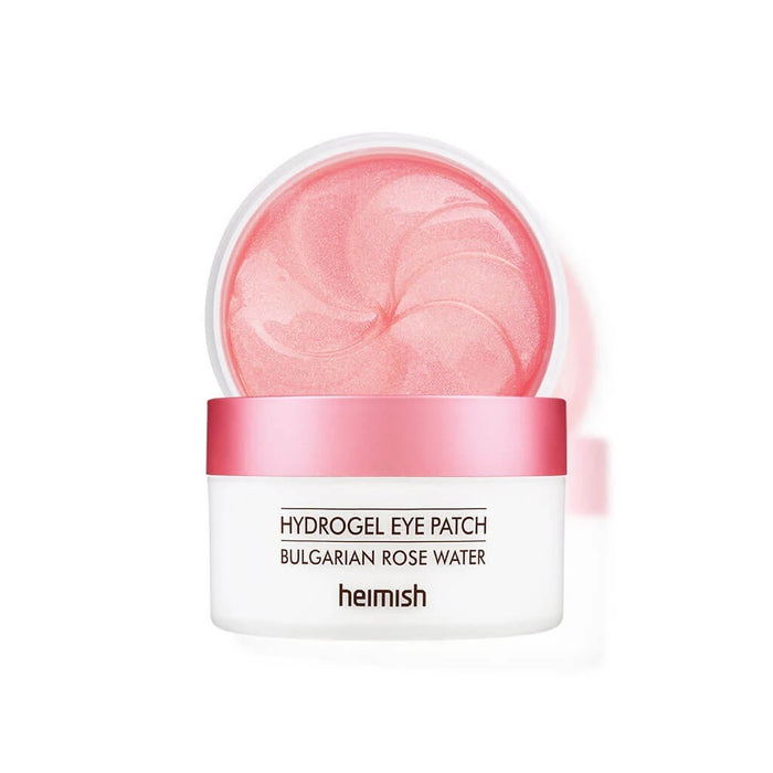 HEIMISH Bulgarian Rose Water Hydrogel Eye Patch is a soothing and hydrating treatment for the delicate under-eye area. Infused with Rosa Damascena Flower Water and Niacinamide, it brightens and revitalizes tired eyes while reducing the appearance of dark circles. Enriched with Centella Asiatica Extract and Sodium Hyaluronate, these hydrogel patches deliver deep hydration and a calming effect. Perfect for daily use or a quick skin refresh, they leave your under-eye area feeling smooth, nourished,