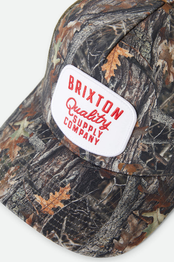 Unisex Hubal Netplus Trucker Hat in the color Tree Camo/Olive - Additional Laydown image