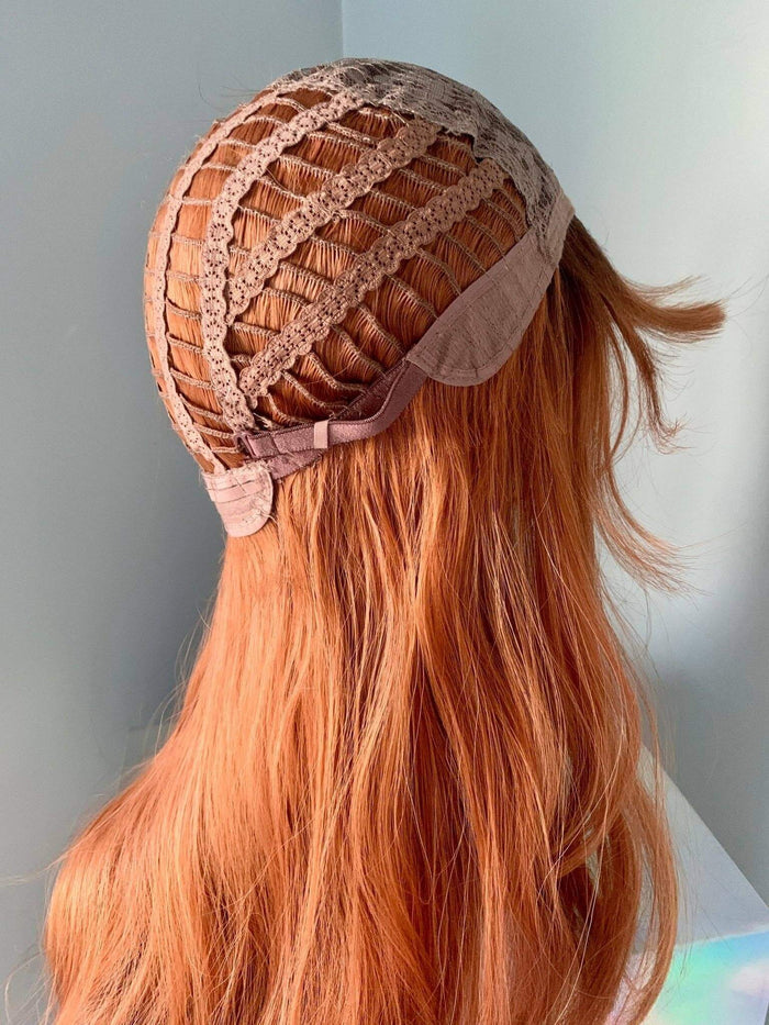 Back view of a Jordan Auburn Wig with Bangs showcasing the cap construction and length of hair.