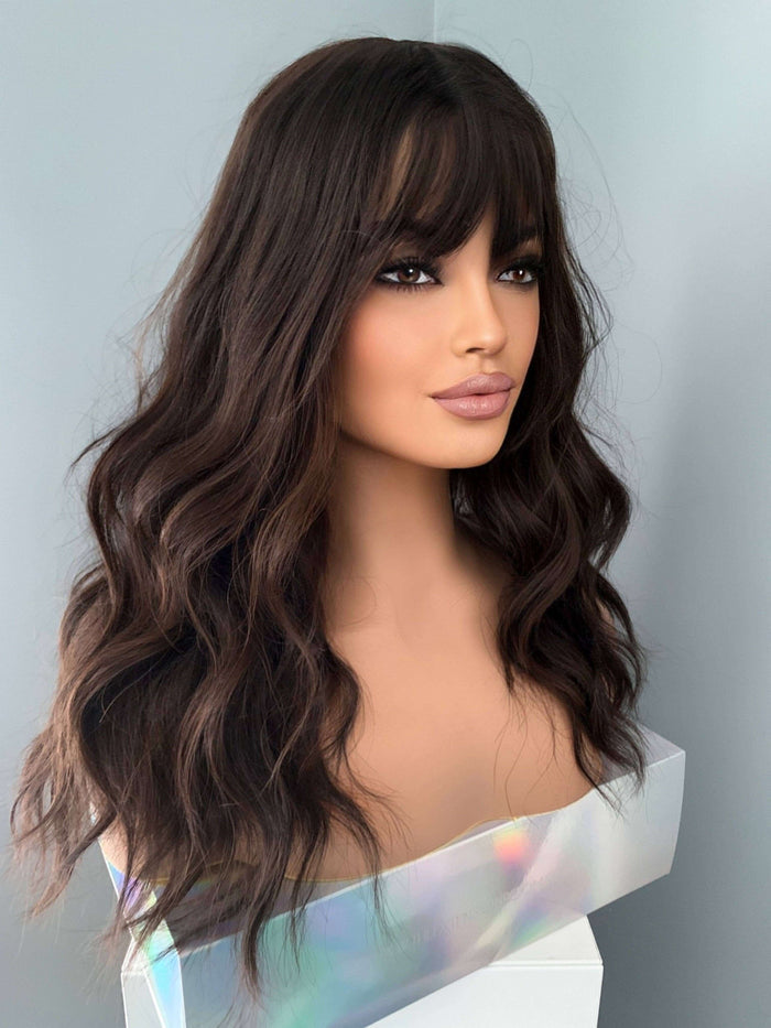 Kayla Long Dark Brown Wig with Bangs by The Extension Room, featuring soft waves and a natural look.