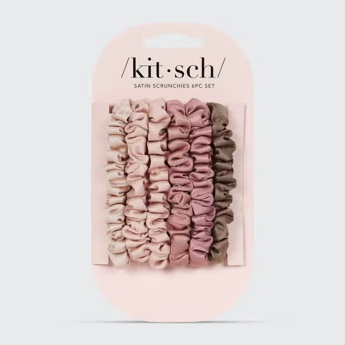 A stack of five KITSCH Ultra Petite Satin Scrunchies, in eco-friendly shades of pink and brown, is arranged from light to dark against a plain white background, offering gentle hair damage reduction.