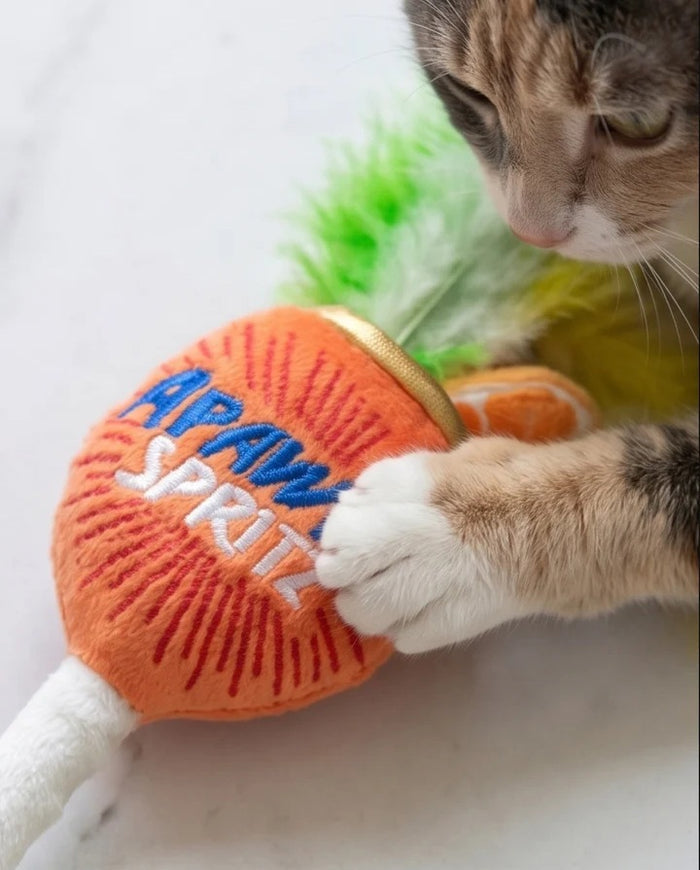 Delight and entertain your feline friend with the KITTY COCKTAILS ORGANIC CATNIP TOYS by HAUTE DIGGITY DOG—this playful set features two plush cat toys shaped like cocktails: one orange with a green feather, labeled "Apawrol Spritz," and one pale green with a yellow feather, labeled "Dirty Catini." Both toys have white stems, gold accents, and are crafted from organic catnip for irresistible feline fun.