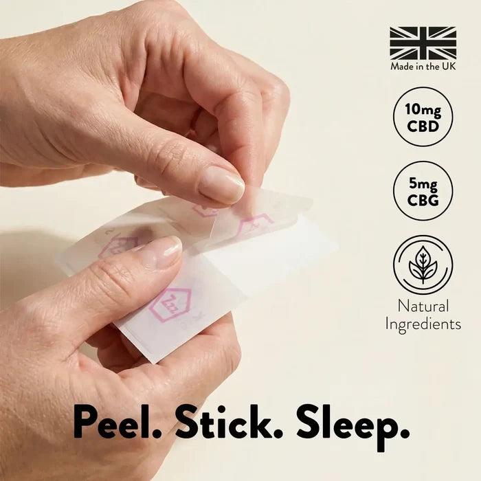 Hands peeling a small adhesive patch with product details on a light background