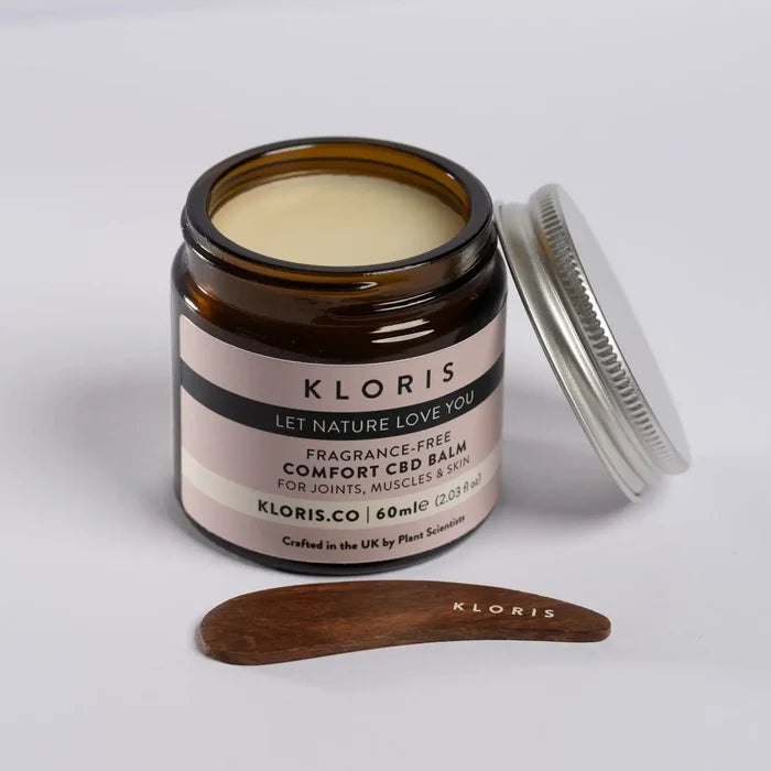 Kloris CBD balm jar with wooden applicator on a white background