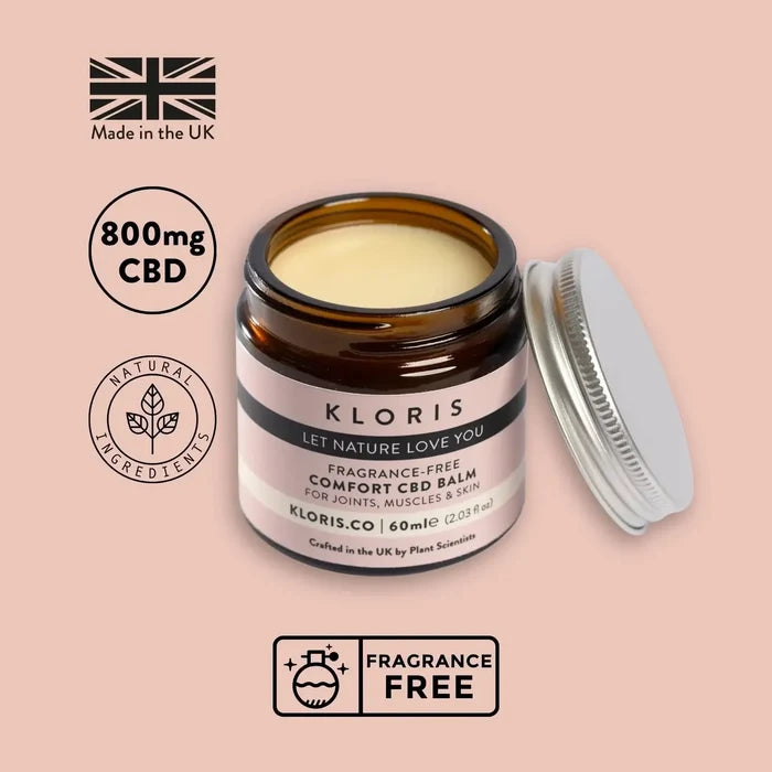 Kloris CBD balm jar with open lid on a pink background, featuring CBD and fragrance-free labels.