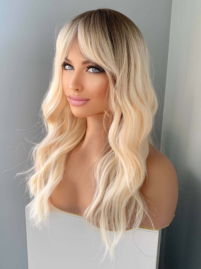 Krista Wavy Blonde Wig with Bangs showcasing soft waves and flattering bangs for a natural, radiant look.