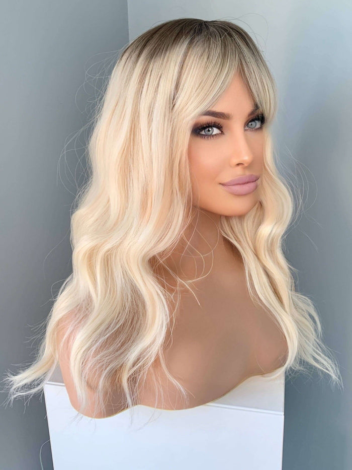 Krista Wavy Blonde Wig with Bangs showcasing soft waves and bangs for a natural look.