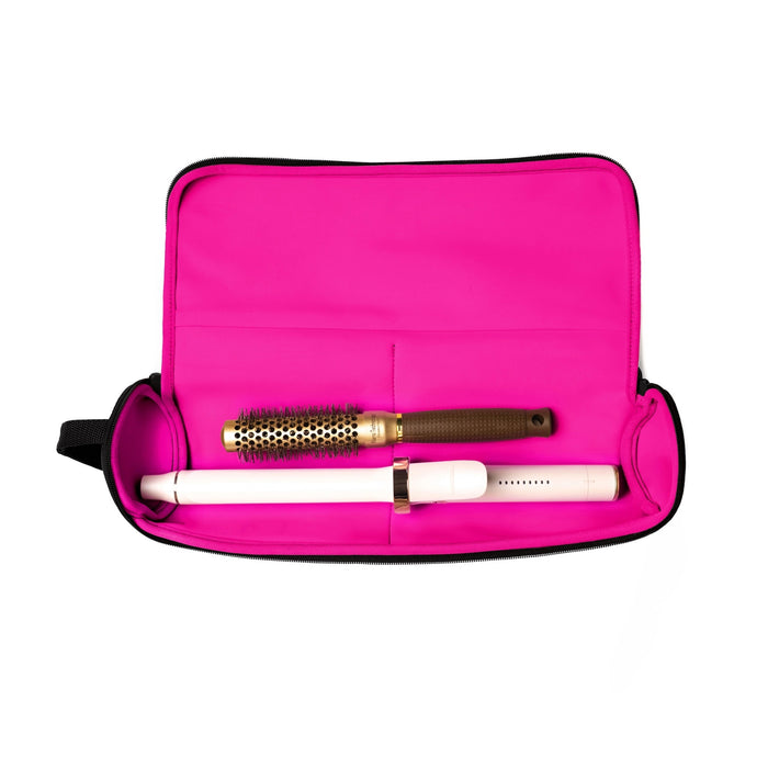 The KUSSHI - HAIR TOOLS TRAVEL CASE IN BLACK is a black cylindrical case by KUSSHI, featuring a handle, black zipper pulls, a white "KUSSHI" label on the front, pink lining accents, and is machine washable for convenience.
