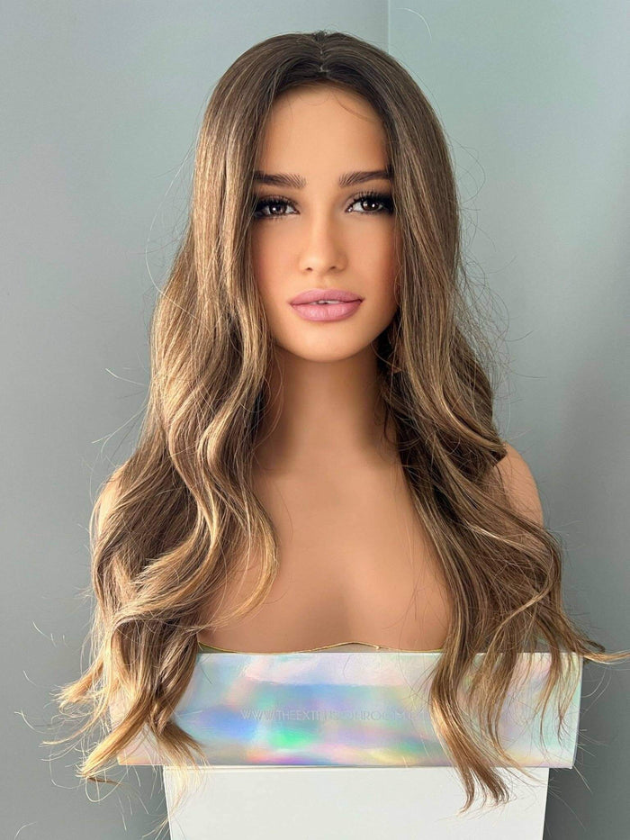 Long Brown Curled Wig displayed on a mannequin with soft, natural-looking curls and a polished finish.