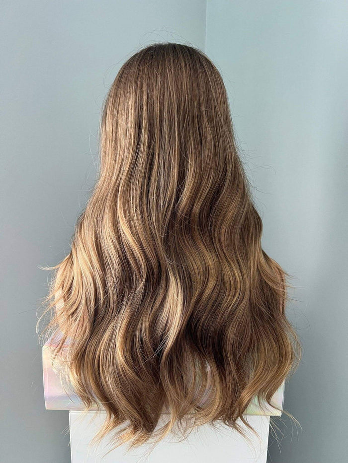 Back view of Kylie Long Brown Curled Wig showcasing stylish, soft, natural-looking curls.