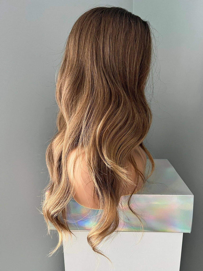 Brown Curled Wig displayed on a mannequin showcasing soft flowing curls and natural volume.