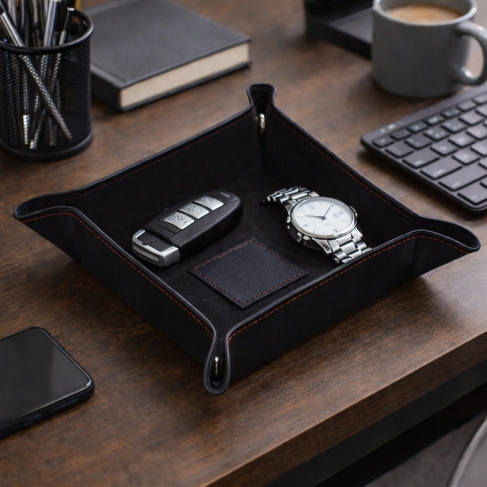 A BEYBERK INTERNATIONAL LEATHER SNAP VALET in black with red stitching, featuring visible edge stitching, is arranged neatly on a white background.