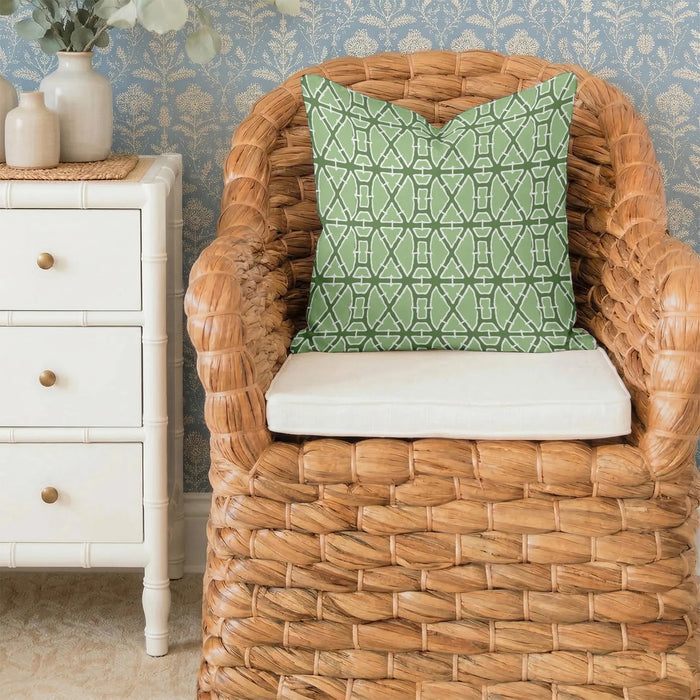 The LOOM & CLOTH Lattice Tailored Pillow in Green features a modern, symmetrical design with a white geometric pattern of repeating abstract shapes on a green cotton background. This decorative throw pillow is finished with tailored edges for an elegant touch.