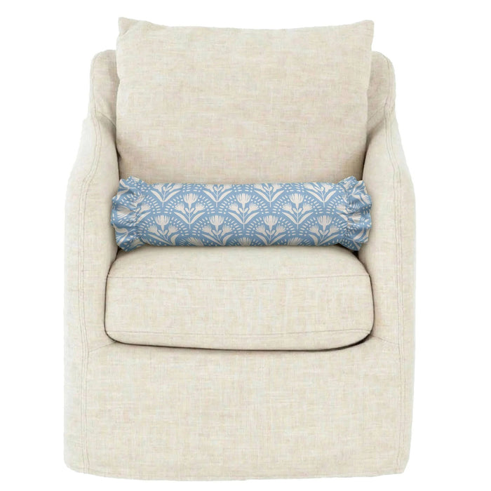 The LOOM AND CLOTH - SERENA RUFFLED BOLSTER PILLOW by LOOM & CLOTH features a cylindrical silhouette with ruffled ends, upholstered in light blue fabric adorned with a white floral pattern, bringing timeless elegance and vintage-chic style to your decor.