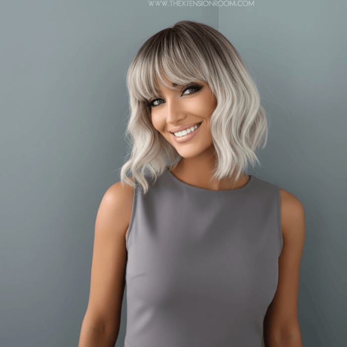 Lucy Short Bob Wig with Bangs styled on a model, showcasing a chic chin-length bob and soft waves.