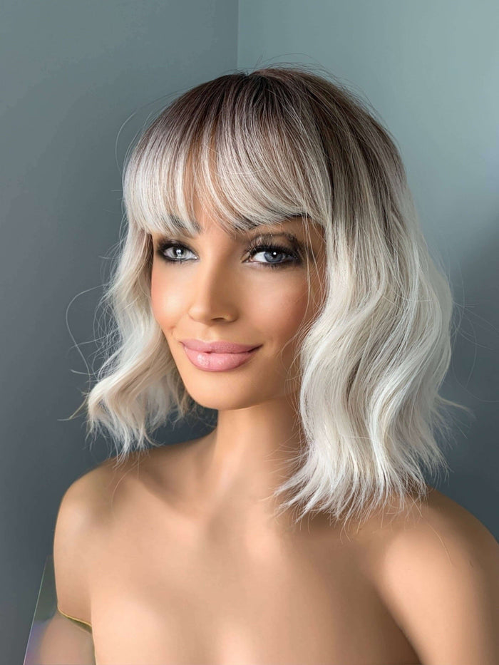 Lucy Short Bob Wig with Bangs showcasing a modern hairstyle with soft waves and full bangs.