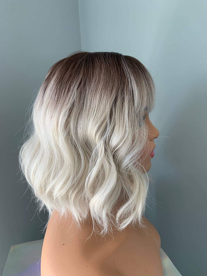 Lucy Short Bob Wig with Bangs showcasing soft waves and a chic look, perfect for a trendy style.