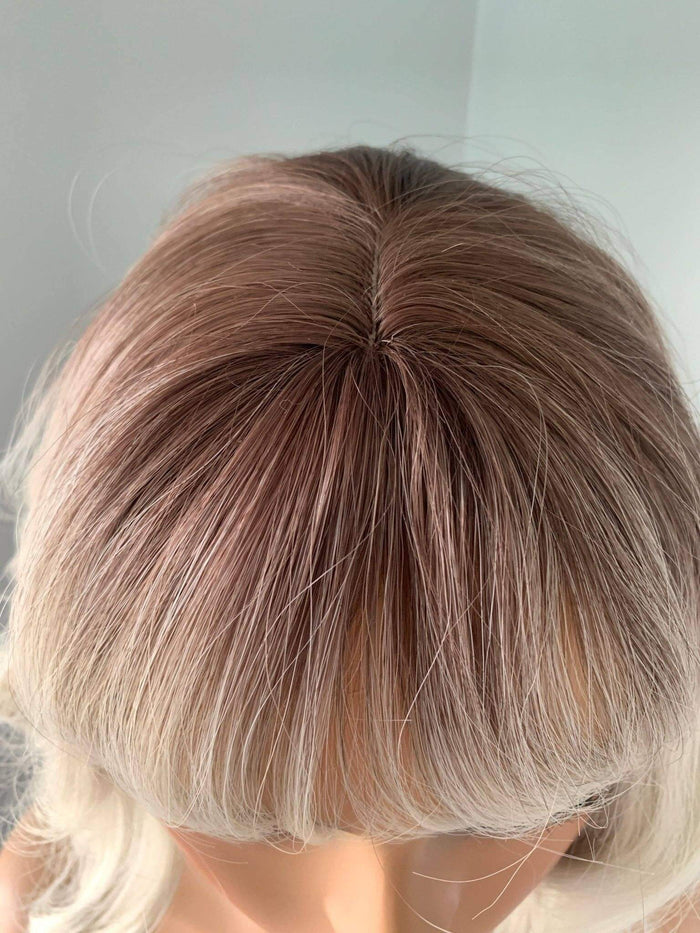 Top view of the Lucy Short Bob Wig with Bangs by The Extension Room, featuring soft waves and a chic blend of colors.