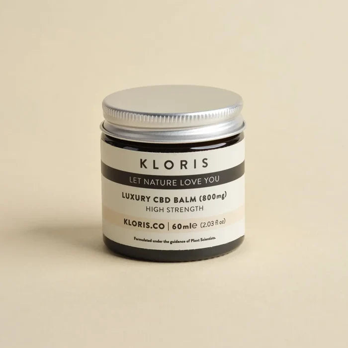 Kloris CBD balm jar on a beige background