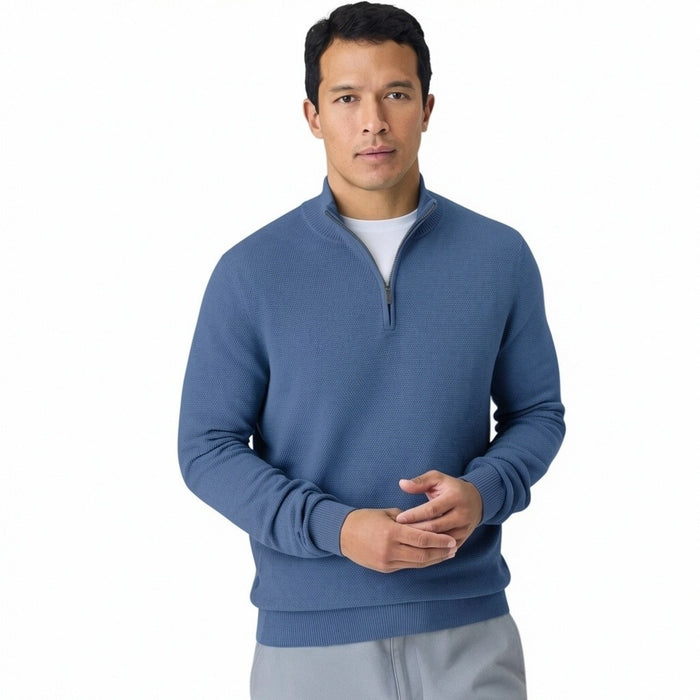 A man faces away from the camera, wearing the MACK WELDON Tech Linen Quarter Zip in Deep Lagoon Heather with COOLMAX® technology and gray pants. The background is plain light gray.