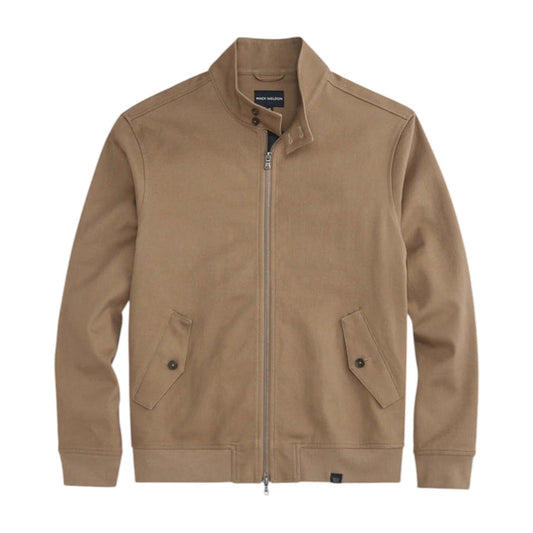 Close-up of a person wearing the MACK WELDON Twill Harrington Jacket in Shroom, featuring a zip front and buttoned flap pocket. Their arm is relaxed by their side and dark denim jeans are partially visible.