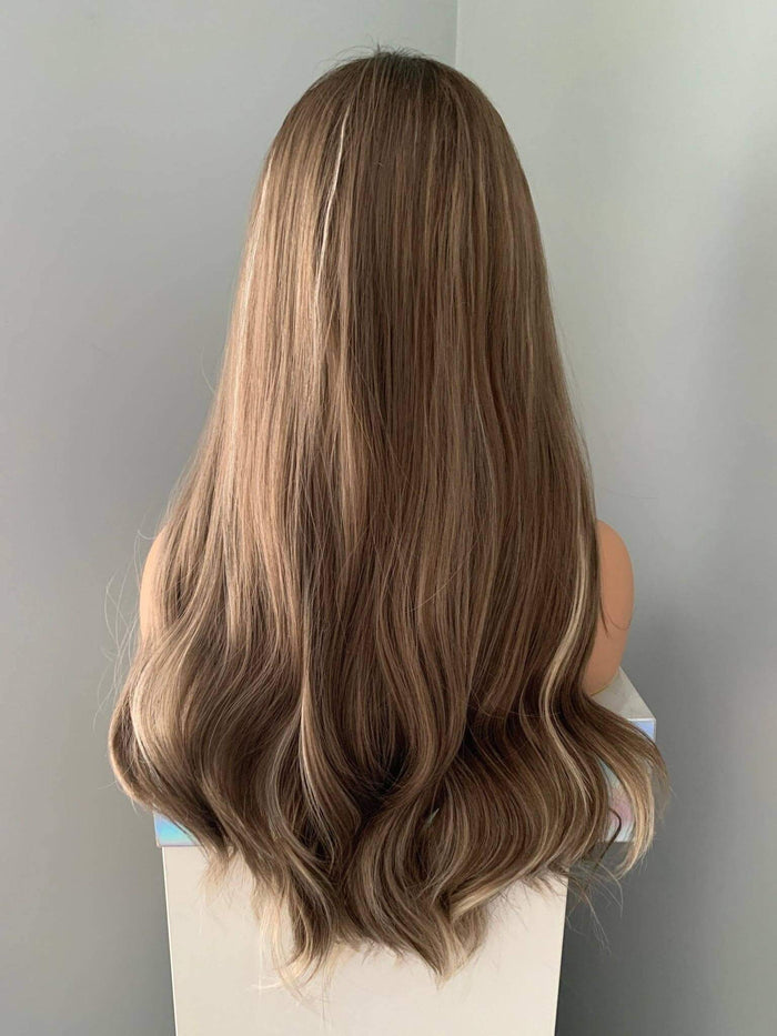 Mannequin head with long, wavy brown hair against a plain background