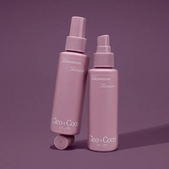 Two purple bottles of 'Cleo + Coco' on a matching purple background