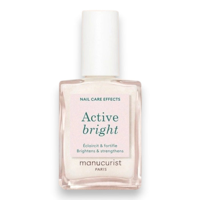 A nail polish brush and swatches appear beside text featuring the MANUCURIST - ACTIVE™ BRIGHT TREATMENT POLISH by MANUCURIST INC, emphasizing easy application, fast drying, a buildable make-up effect, and an enriched formula with active ingredients—perfect for plant-based nail care or as a brightening treatment polish.